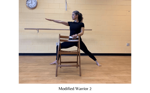 Modified Warrior 2 holding chair - yoga poses for cancer patients