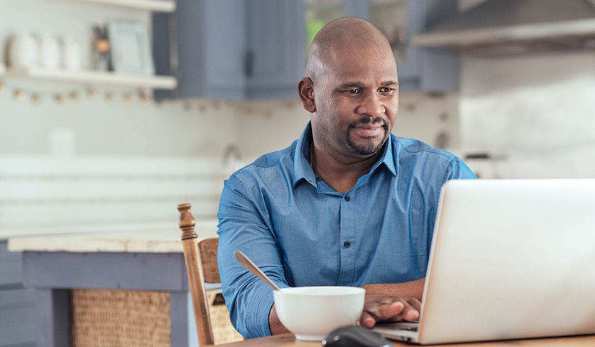 genetic testing for prostate cancer - is it right for you? - black man at laptop doing research on prostate cancer